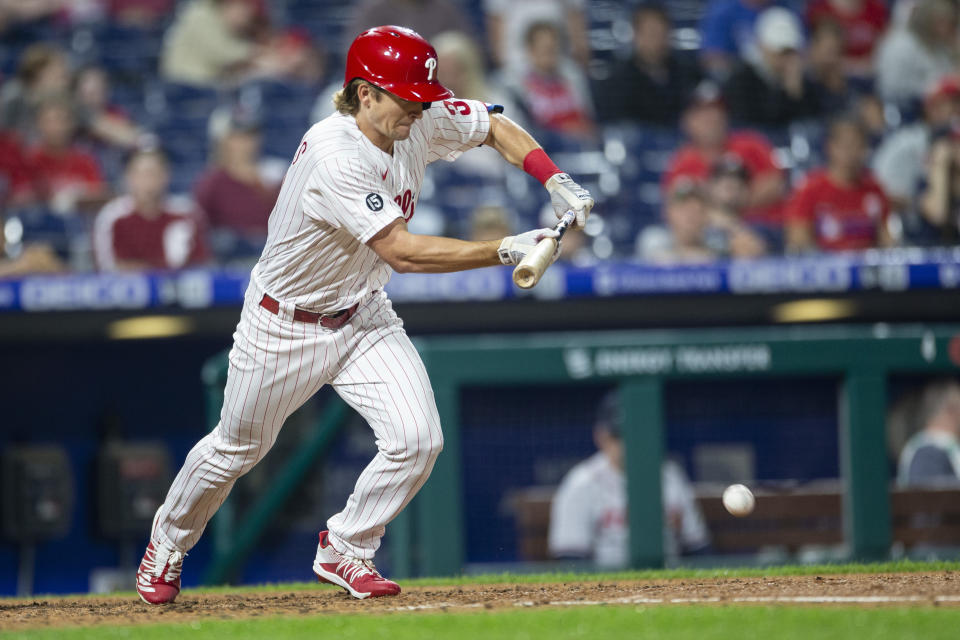 Philadelphia Phillies' Luke Williams bunts for a single during the fifth inning of a baseball game against the Atlanta Braves, Tuesday, June 8, 2021, in Philadelphia. Williams advanced to third on an error. (AP Photo/Laurence Kesterson)