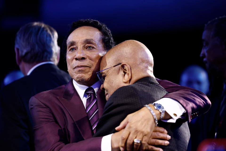 Smokey Robinson and Berry Gordy embrace onstage during MusiCares Persons of the Year Honoring Berry Gordy and Smokey Robinson at Los Angeles Convention Center on Feb 3, 2023, in Los Angeles.