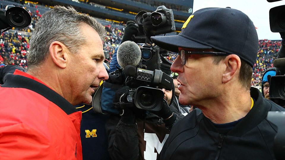 Urban Meyer and the Buckeyes face Jim Harbaugh’s Wolverines on Saturday at noon ET. Harbaugh is seeking his first victory as Michigan’s head coach against rival Ohio State. (Getty)