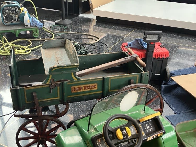 A 1912 John Deere Junior wagon is among three ride-on toys that will be displayed on a platform in the exhibit.