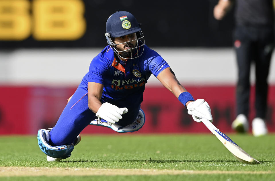 India's Shreyas Iyer dives to avoid a run out by New Zealand during their one day international cricket match in Auckland, New Zealand, Friday, Nov. 25, 2022. (Andrew Cornaga/Photosport via AP)