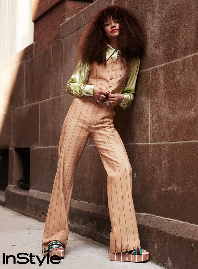 <p>Zendaya in an Acne Studios vest, shirt, trousers, and belt with&nbsp;Lunch at the Ritz for Brandon Maxwell<b> </b>earrings,&nbsp;Jennifer Fisher rings, and&nbsp;DVF<b> </b>flatforms.</p>