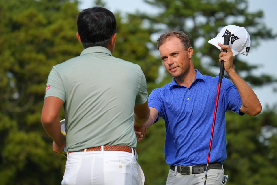 Takumi Kanaya (L) of Japan and Eric Cole (R) of the United States shake hands after holing out on the 9th green during the first round of the ZOZO Championship at Accordia Golf Narashino Country Club on October 19, 2023, in Inzai, Chiba, Japan. (Photo by Yoshimasa Nakano/Getty Images)