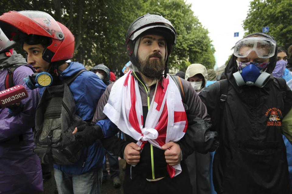 Demonstrators stand in front of police block during an opposition protest against "the Russian law" near the Parliament building in the center of Tbilisi, Georgia, Tuesday, May 14, 2024. The Georgian parliament on Tuesday approved in the third and final reading a divisive bill that sparked weeks of mass protests, with critics seeing it as a threat to democratic freedoms and the country's aspirations to join the European Union. (AP Photo/Zurab Tsertsvadze)