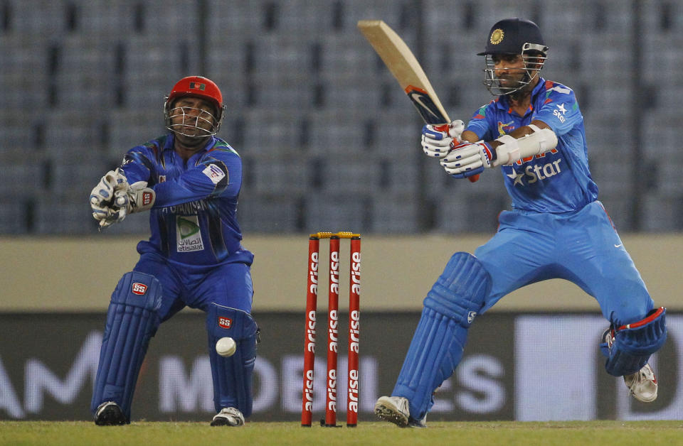 India’s Ajinkya Rahane, right, plays a shot as Afghanistan’s Mohammad Shahzad watches during their match in the Asia Cup one-day international cricket tournament in Dhaka, Bangladesh, Wednesday, March 5, 2014. (AP Photo/A.M. Ahad)