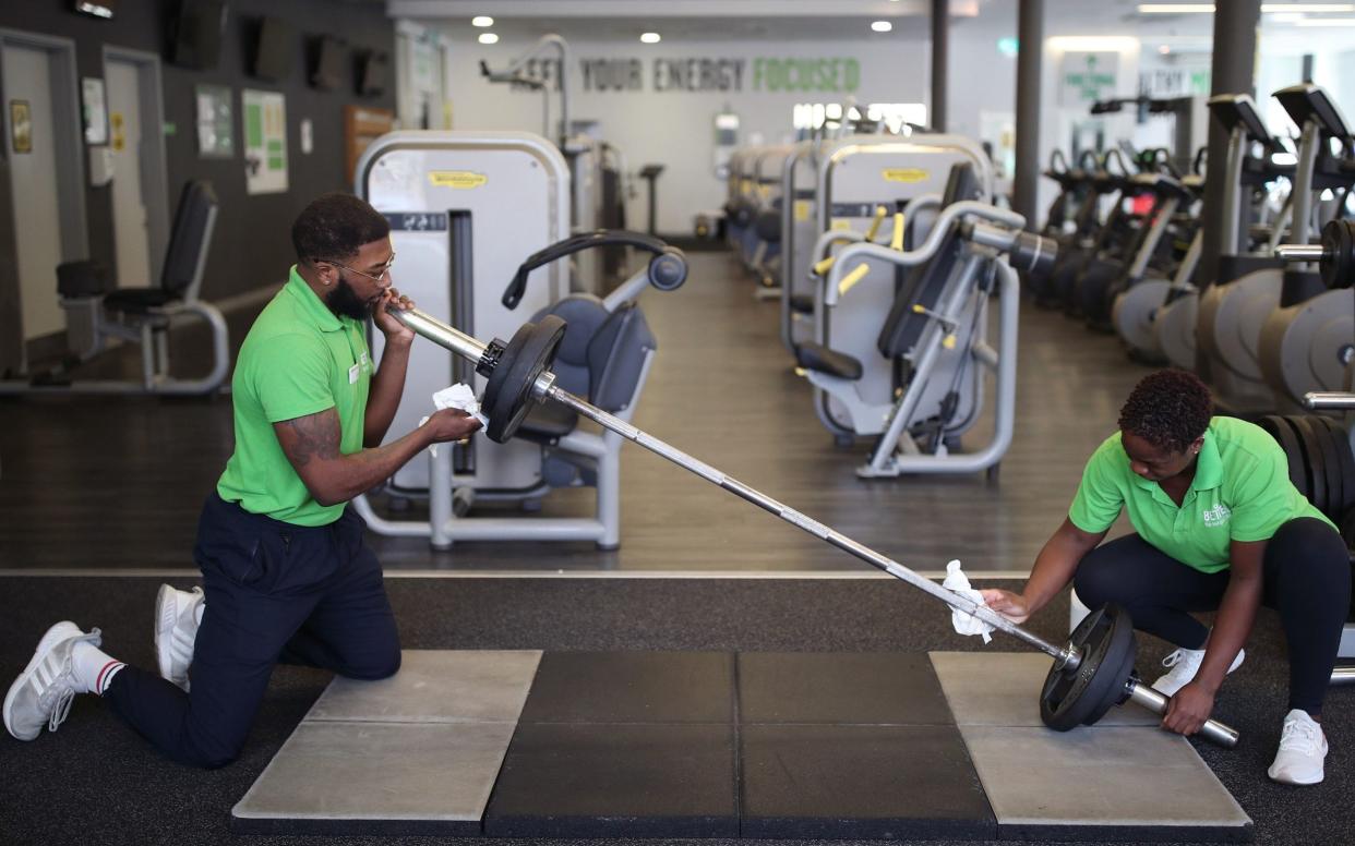 Staff members at Clapham Leisure Centre, south London, ready the gym facilities, as they prepare for reopening on April 12 - Yui Mok /PA