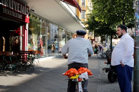 People meet in the street in Berlin's Kreuzberg district, Germany, August 19, 2016. Picture taken August 19, 2016. REUTERS/Axel Schmidt