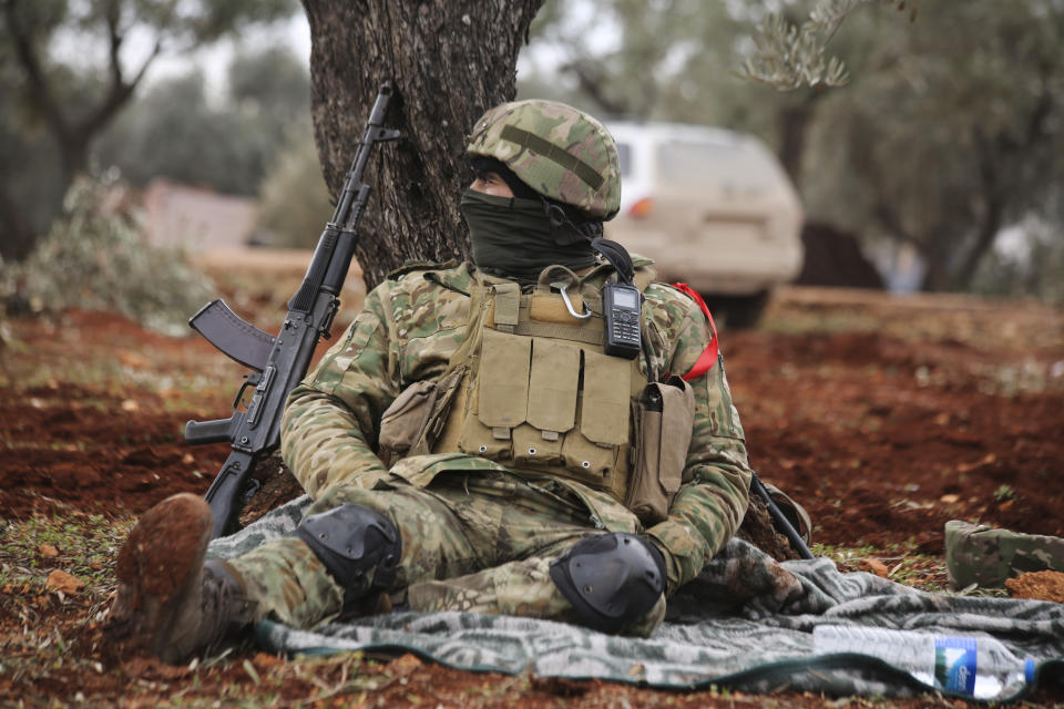 Turkish backed Syrian fighters prepare to go to frontline in Idlib province, Syria. Tuesday, Feb. 11, 2020. The fighting on Tuesday concentrated near the village of Nairab as rebels, with the backing of Turkish artillery, tried to retake the village that they lost last week, according to opposition activists. (AP Photo/Ghaith Alsayed)