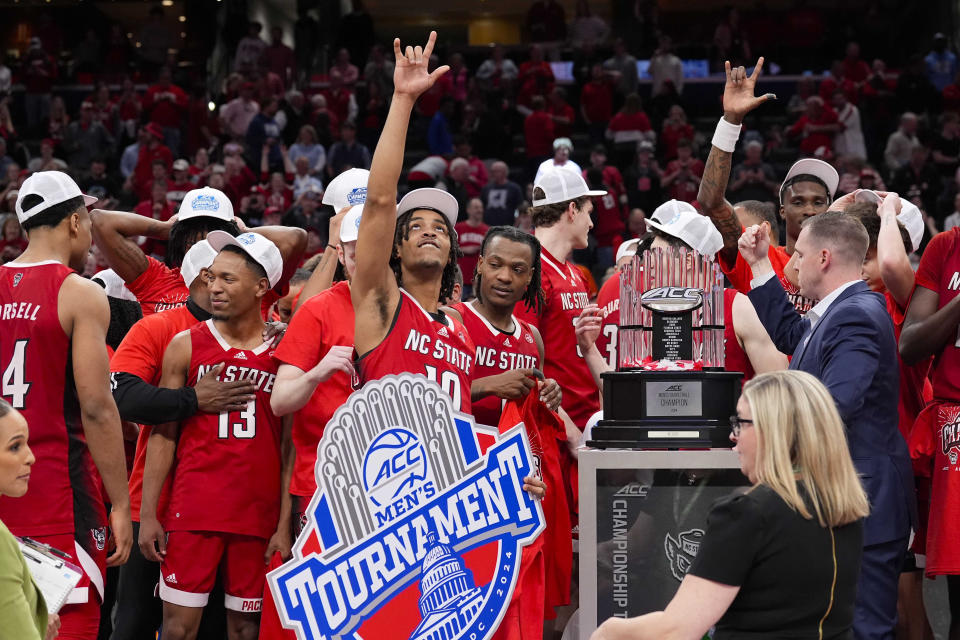 North Carolina State guard Breon Pass (10) and his teammates celebrating after winning an NCAA college basketball game against North Carolina to win the championship of the Atlantic Coast Conference tournament, Saturday, March 16, 2024, in Washington. North Carolina State won 84-76. (AP Photo/Alex Brandon)