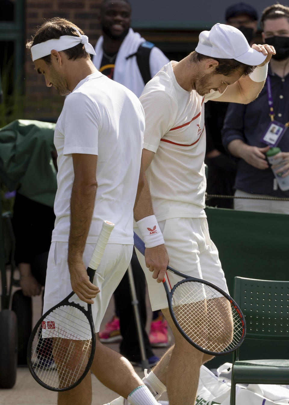 Switzerland's Roger Federer, left, and Britain's Andy Murray on Court 14 for a practice session prior to the Wimbledon Tennis Championships in London, Friday June 25, 2021. (David Gray/Pool via AP)