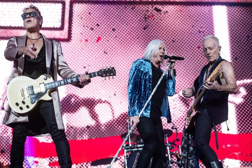 Def Leppard's Vivian Campbell (from left), Joe Elliott and Phil Collen perform in Denmark June 14, 2023. The band is back in U.S. stadiums this summer on a co-headlining tour with Journey.