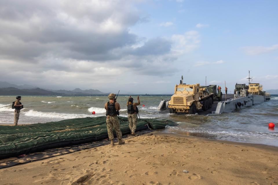 military ships unloading equipment