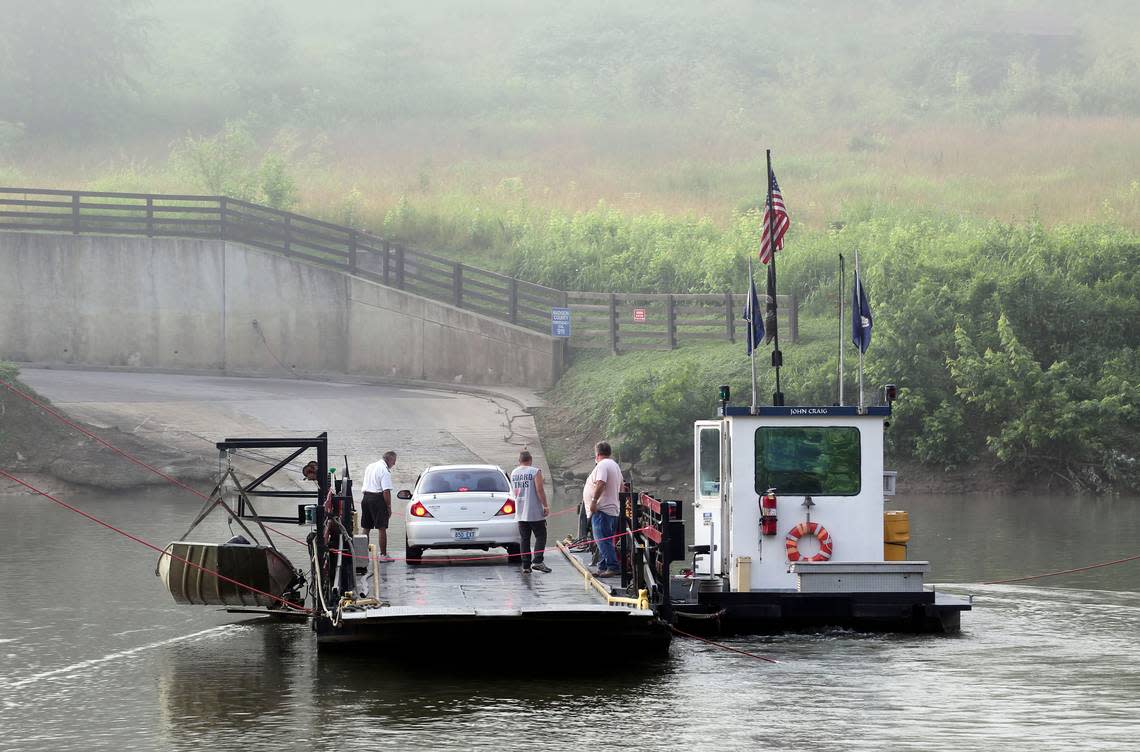 Capt. Will Horn, left, talked to a motorist as the ferry crossed the Kentucky River. The retirement last week of the only other captain forced the ferry to cut its operating hours and days.