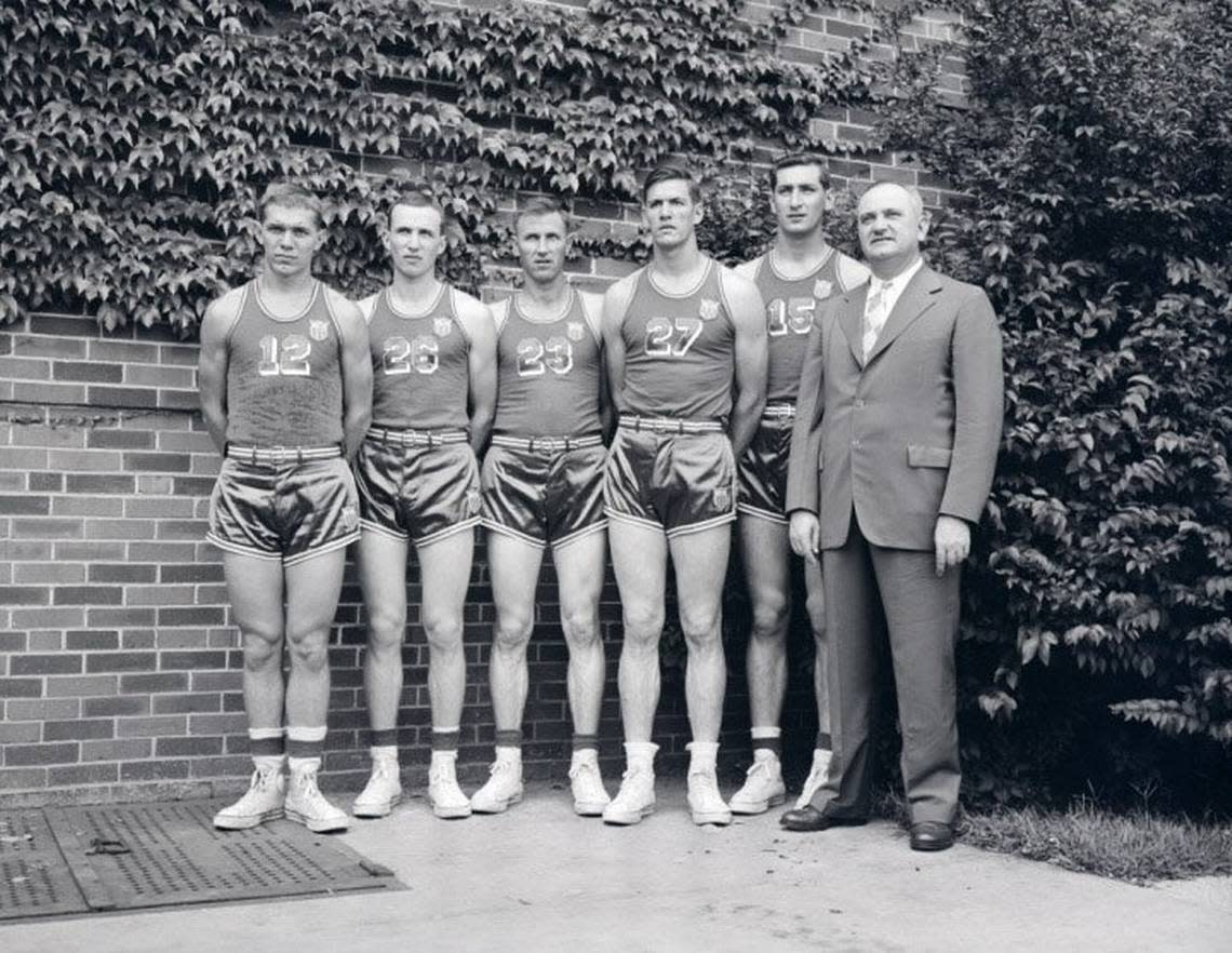 Kentucky men’s basketball players in their 1948 Olympic uniforms, from left: Ralph Beard, Kenny Rollins, Cliff Barker, Wallace “Wah Wah” Jones and Alex Groza, along with Coach Adolph Rupp