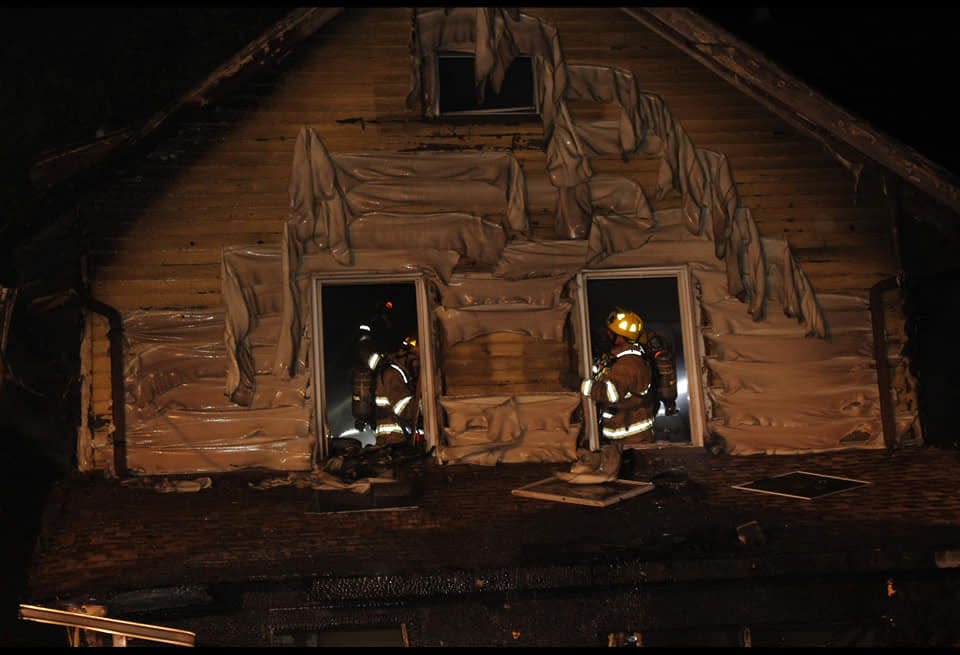 In thIs photo released by the Erie Fire department, firefighters work to put out a house fire in Erie, Pennsylvania, on Aug. 11, 2019.