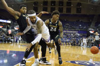 Washington guard PJ Fuller, center, eyes the ball as he dives out of bounds between Colorado guards KJ Simpson, left, and Elijah Parquet (24) during the first half of an NCAA college basketball game, Thursday, Jan. 27, 2022, in Seattle. (AP Photo/Ted S. Warren)