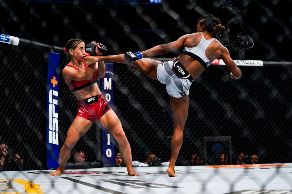 Angela Hill lands a kick on Tecia Torres during their Strawweight fight in Houston, Texas.