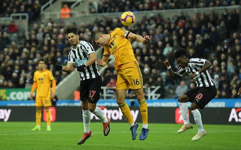 Ayoze Perez of Newcastle United scores his team's first goal ahead of Conor Coady of Wolverhampton Wanderer - Credit:  Stu Forster/Getty Images