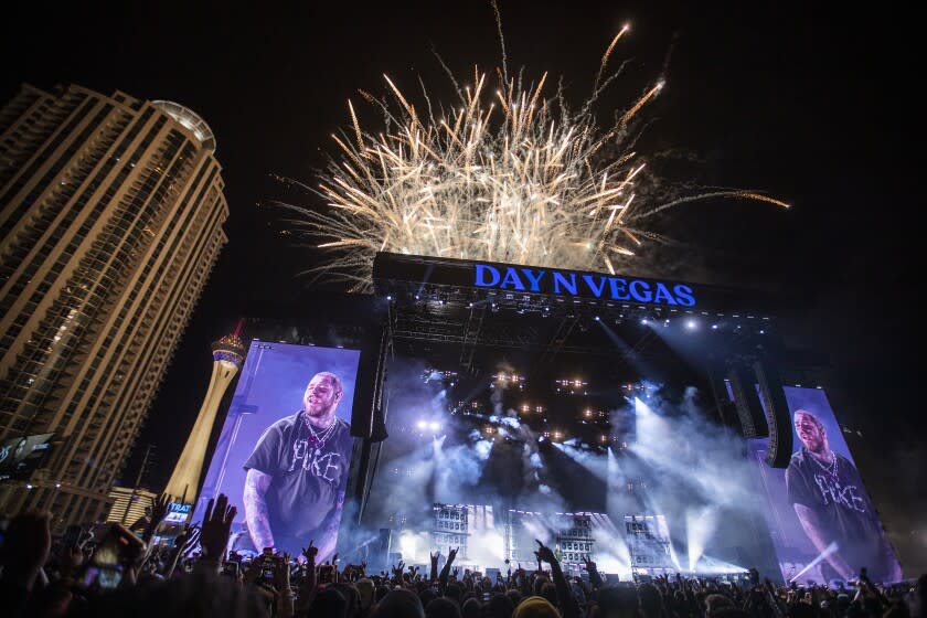 Fireworks over a large music festival stage.