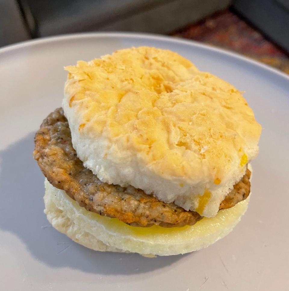 The breakfast sandwich sitting on a plate