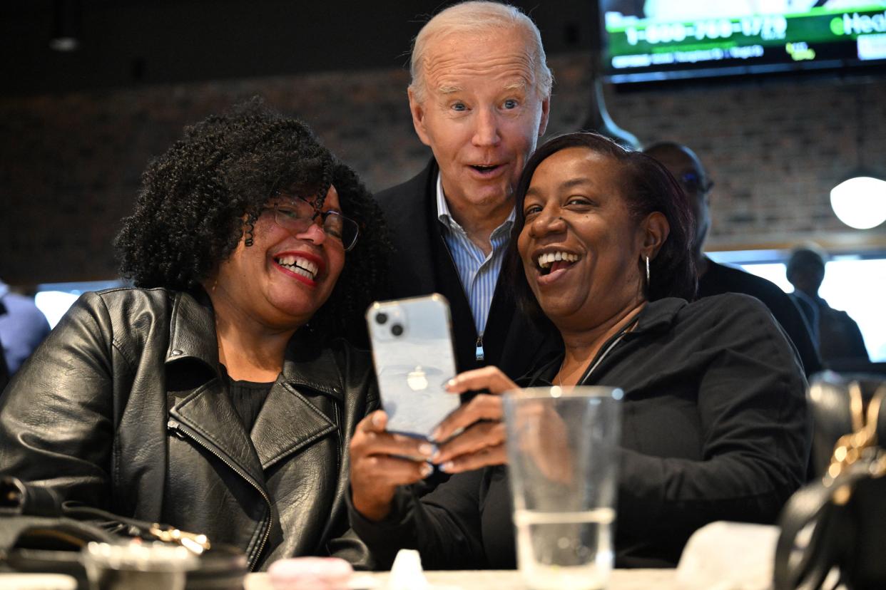 President Joe Biden poses with patrons at They Say restaurant in Harper Woods, Michigan, on February 1, 2024.