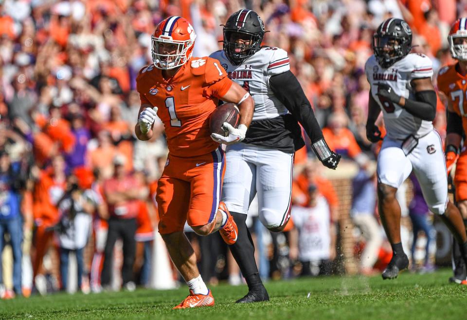 Clemson running back Will Shipley (1) runs by South Carolina defensive tackle Tonka Hemingway (91) during the first quarter at Memorial Stadium in Clemson, South Carolina Saturday, Nov. 26, 2022.   