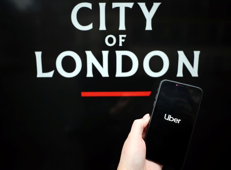 The Uber logo is displayed on a mobile phone in this picture illustration