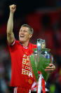 Bastian Schweinsteiger of Bayern Muenchen holds the trophy after winning the UEFA Champions League final match.