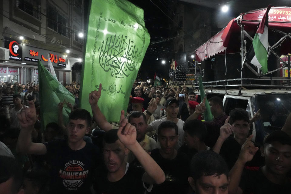 Hamas supporters wave green Islamic flags and their national flags while chanting slogans during a protest against an Israeli military raid in the West Bank city of Jenin, at the main road of Jebaliya refugee camp, northern Gaza Strip, Monday, July 3, 2023. Israel struck targets in a militant stronghold in the occupied West Bank with drones early Monday and deployed hundreds of troops in the area. Palestinian health officials said at least eight Palestinians were killed. (AP Photo/Adel Hana)