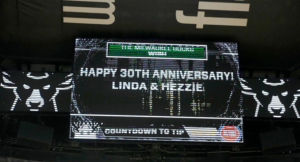 Linda Nation and her husband Hezzie Jack, who are celebrating their 30th wedding anniversary, are honored on the arena floor before the Milwaukee Bucks game against the Detroit Pistons at Fiserv Forum in Milwaukee, Wis., on Monday, Oct. 31, 2022. Linda, who works in the BMO Club while Hezzie works in BMO guest services, both started working Bradley Center events in the early 2000s and have continued on at Fiserv Forum.