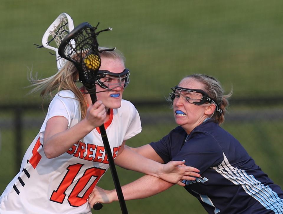 Greeley's Erica Rosendorf (10) tries to drive around  Ursuline Maddy Mobilia (1) during girls lacrosse Class A semifinal at Horace Greeley High School in Chappaqua May 23, 2023. Greeley won the game 11-8.