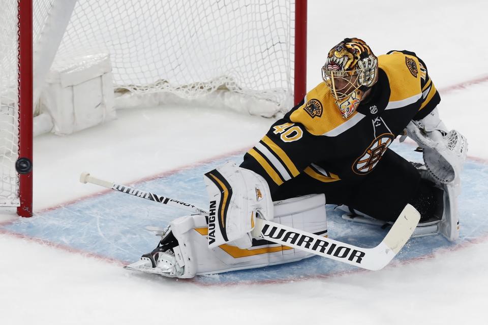 Boston Bruins' Tuukka Rask deflects a shot during the third period in Game 4 of the team's NHL hockey Stanley Cup first-round playoff series against the Washington Capitals, Friday, May 21, 2021, in Boston. (AP Photo/Michael Dwyer)
