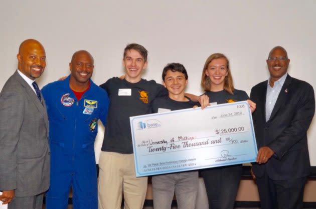 University of Michigan rocketeers get the traditional oversized check from Base 11 Challenge organizers and retired astronaut Leland Melvin. (Base 11 Photo)