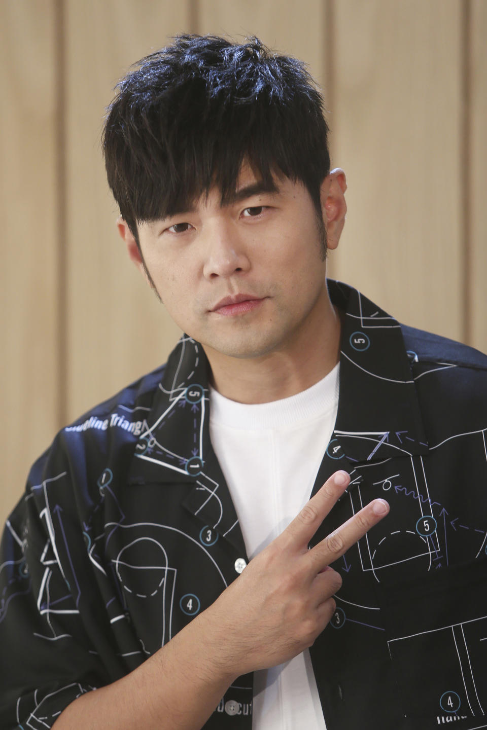 In this Sunday, April 26, 2020, photo, Mandopop superstar Jay Chou poses for a photo as he talks about his latest Netflix show "J-Style Trip" and life with his children during an interview with The Associated Press in Taipei, Taiwan. (AP Photo/Chiang Ying-ying)