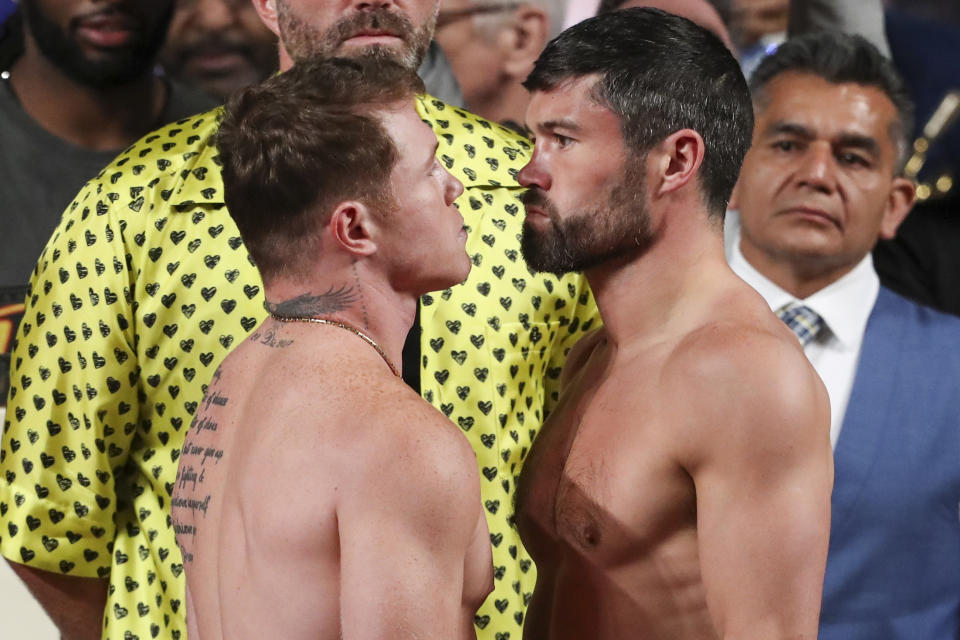 Boxers Saul "Canelo" Alvarez of Mexico, left, and John Ryder of Britain, face each other during their weigh-in ceremony in Guadalajara, Mexico, Friday, May 5, 2023. Alvarez and Ryder will meet for a super middleweight championship fight at Akron Stadium on May 6. (AP Photo/Refugio Ruiz)