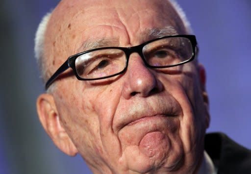 A British parliamentary report says Rupert Murdoch, seen here in 2011, showed "wilful blindness" over phone hacking at his News of the World tabloid and was not fit to run a major company