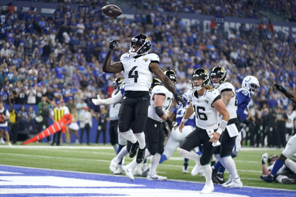 Jacksonville Jaguars running back Tank Bigsby (4) celebrates after scoring as teammate Trevor Lawrence (16) watches during the second half of an NFL football game against the Indianapolis Colts Sunday, Sept. 10, 2023, in Indianapolis. (AP Photo/Darron Cummings)