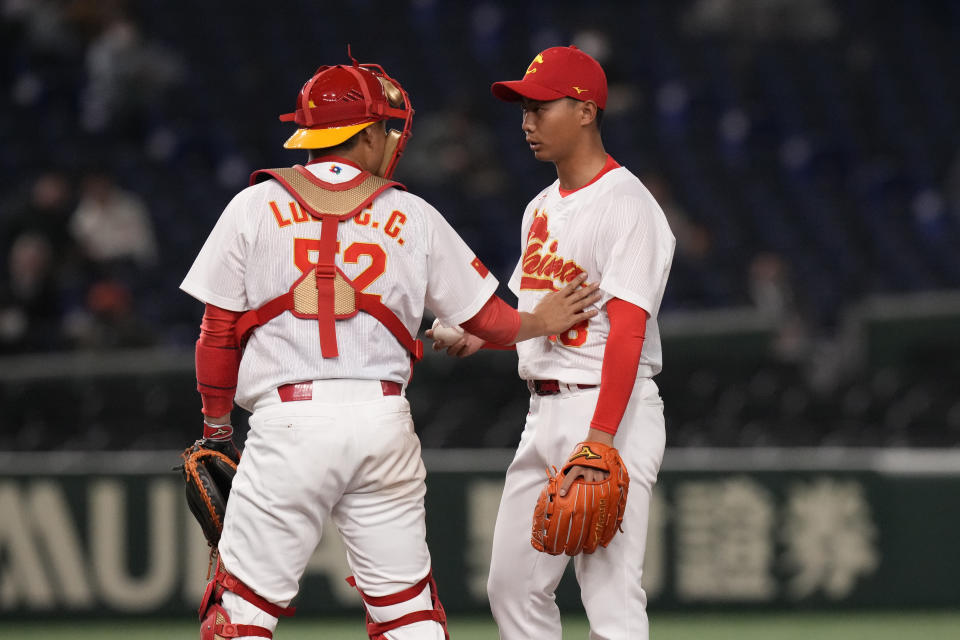 Luan Chenchen of China, left, talks to Sun hailing of China on the mound during the fourth inning of the first round Pool B game between the South Korea and China at the World Baseball Classic (WBC) at Tokyo Dome in Tokyo, Japan, Monday, March 13, 2023. (AP Photo/Eugene Hoshiko)