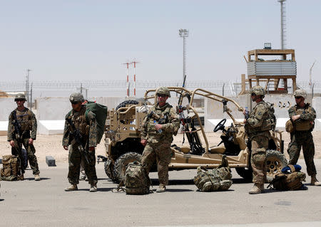 U.S. troops wait for airplane at the Camp Bastion in Helman province, Afghanistan July 4, 2017. REUTERS/Omar Sobhani/Files