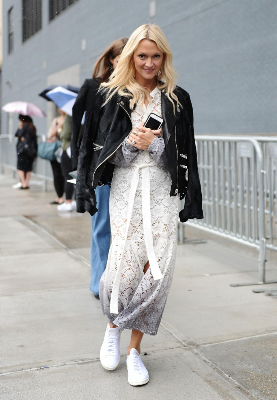 Zanna Roberts Rassi in a white dress and leather jacket at New York Fashion Week.