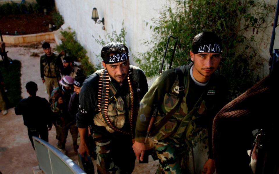 Syrian fighters of "The Beloved of Allah," brigade seen before fighting with government forces on the outskirts of Aleppo in 2012 - AP Photo/Khalil Hamra, File