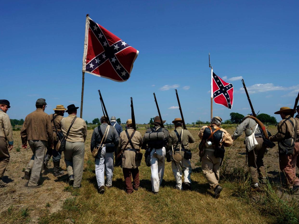 Civil War reenactors march with Confederate flags at Gettysburg, were armed militia met on Saturday: AP