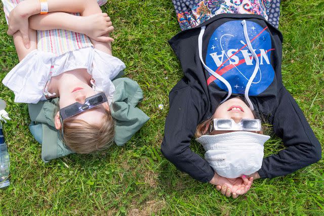 <p>CLAUS BECH/Ritzau Scanpix/AFP via Getty </p> Children watching a solar eclipse in Tollose, Denmark, on June 10, 2021