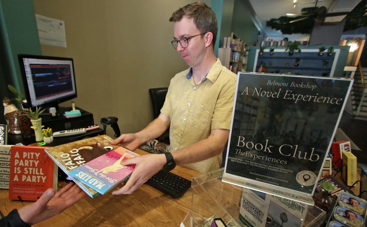 Brian Frederick waits on a customer at the Belmont Bookshop Saturday afternoon, April 13, 2024.