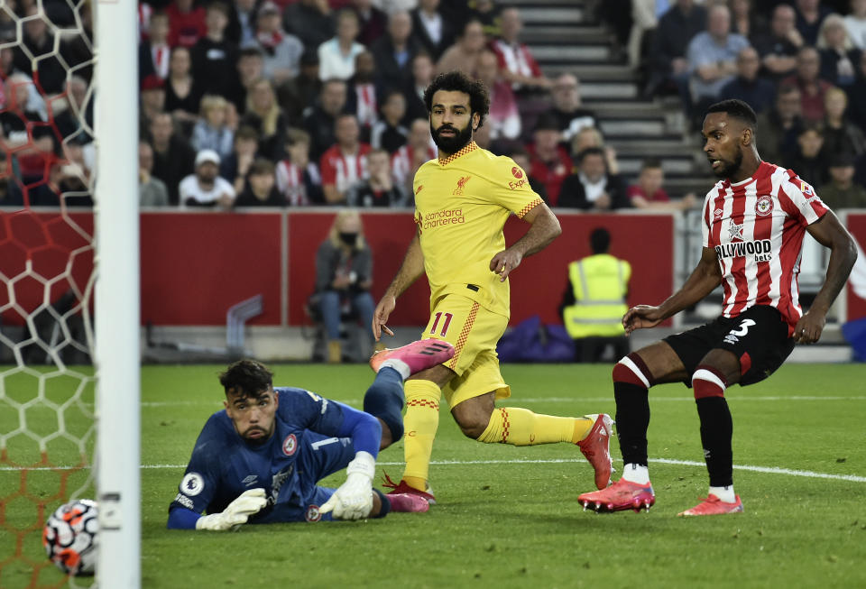 Liverpool's Mohamed Salah, center, scores his side's second goal during the English Premier League soccer match between Brentford and Liverpool at the Brentford Community Stadium in London, Saturday, Sept. 25, 2021. (AP Photo/Rui Vieira)