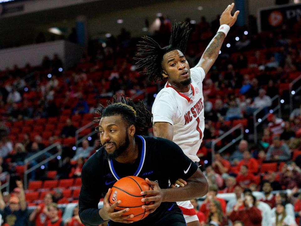 Saint Louis’ Terrence Hargrove Jr. pulls down a rebound in front of N.C. State’s Jayden Taylor during the first half of the Wolfpack’s game on Wednesday, Dec. 20, 2023, at PNC Arena in Raleigh, N.C.