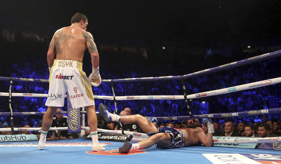 Tony Bellew, right is knocked down in the eighth round by Oleksandr Usyk during their cruiserweight boxing bout Saturday, Nov. 10, 2018, in Manchester, England. Usyk successfully defended his four belts and likely sent Bellew into retirement by knocking out the British fighter in the eighth round. (Nick Potts/PA via AP)