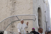 Pope Francis greets faithful as leaves St. Nicholas Basilica after meeting with bishops on the occasion of the "Mediterranean sea a border of peace" conference in Bari, Italy, Sunday, Feb. 23, 2020. (AP Photo/Gregorio Borgia)