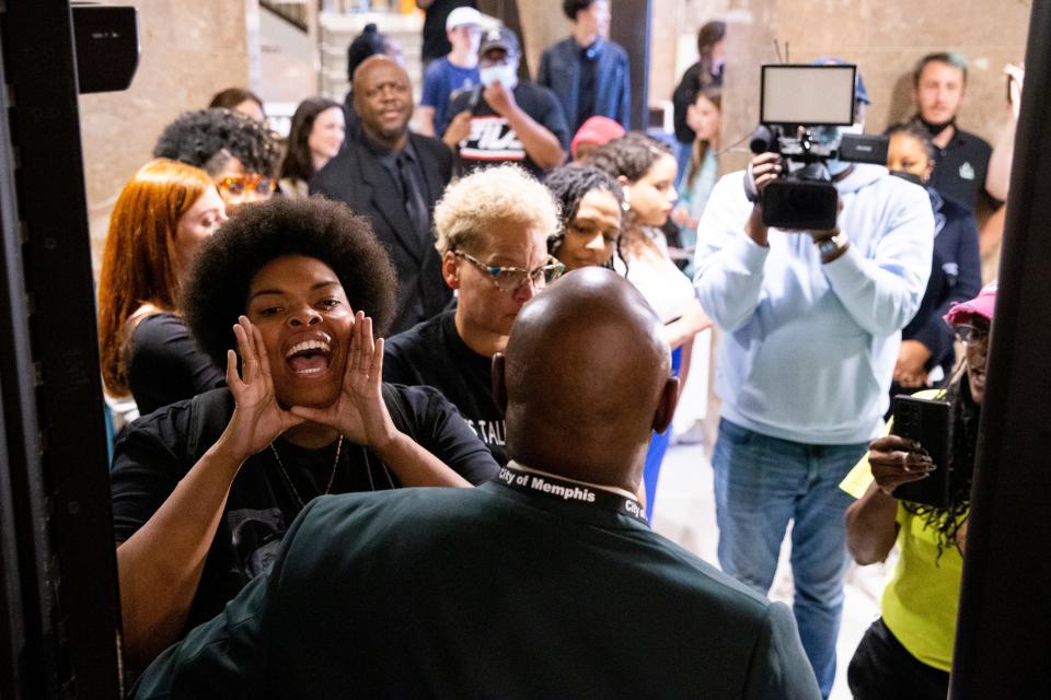 Amber Sherman, president of Shelby County Young Democrats, shouts at City Council Chairman Martavius Jones while she is blocked by Cedric Young, chief security officer, after being previously banned from City Council meetings during a Memphis City Council meeting on Tuesday, April 11, 2023. “I think the City Council Chairman Martavius Jones is targeting people who are outspoken,” Sherman said. “He himself called me a ringleader and I think that’s very targeted language to use against folks who’ve been advocating and want to see change.”