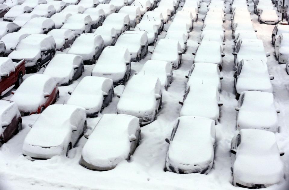 Cars are covered by snow in rental car parking lot at O'Hare International Airport in Chicago, Thursday, Jan. 2, 2014. Another one to three inches of snow could fall across the Chicago metro area today with even more falling in the southern part of the region, according to the National Weather Service. (AP Photo/Nam Y. Huh)